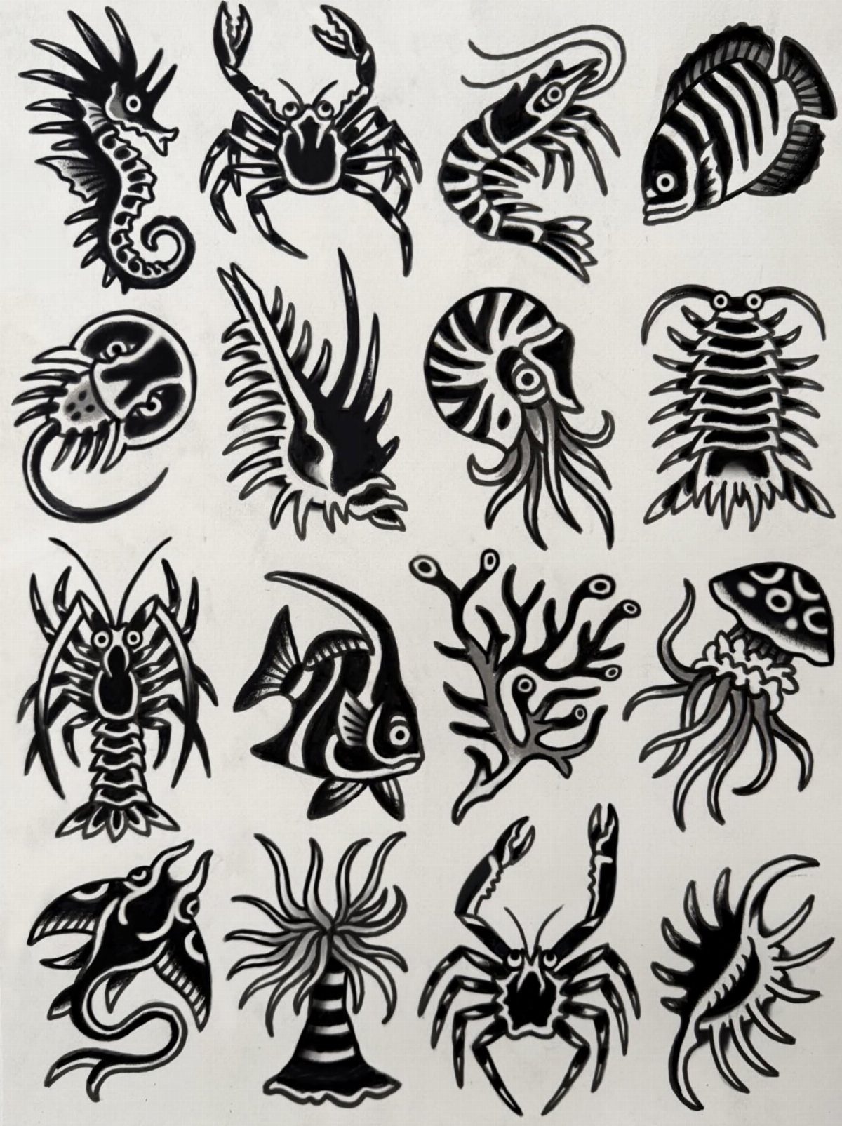 Black ink marine life tattoo flash designs including crabs, fish, and jellyfish on white paper.