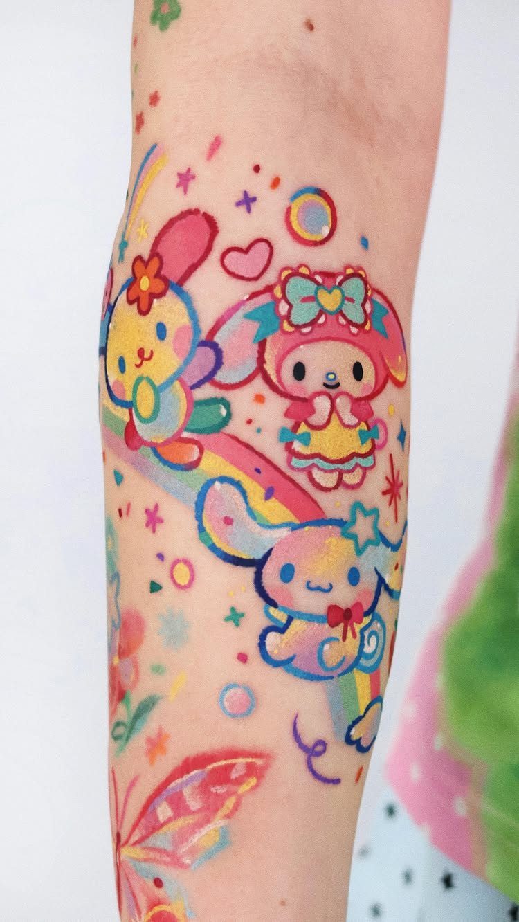 Colorful pastel cartoon character tattoos on a person's arm featuring stars and a butterfly.