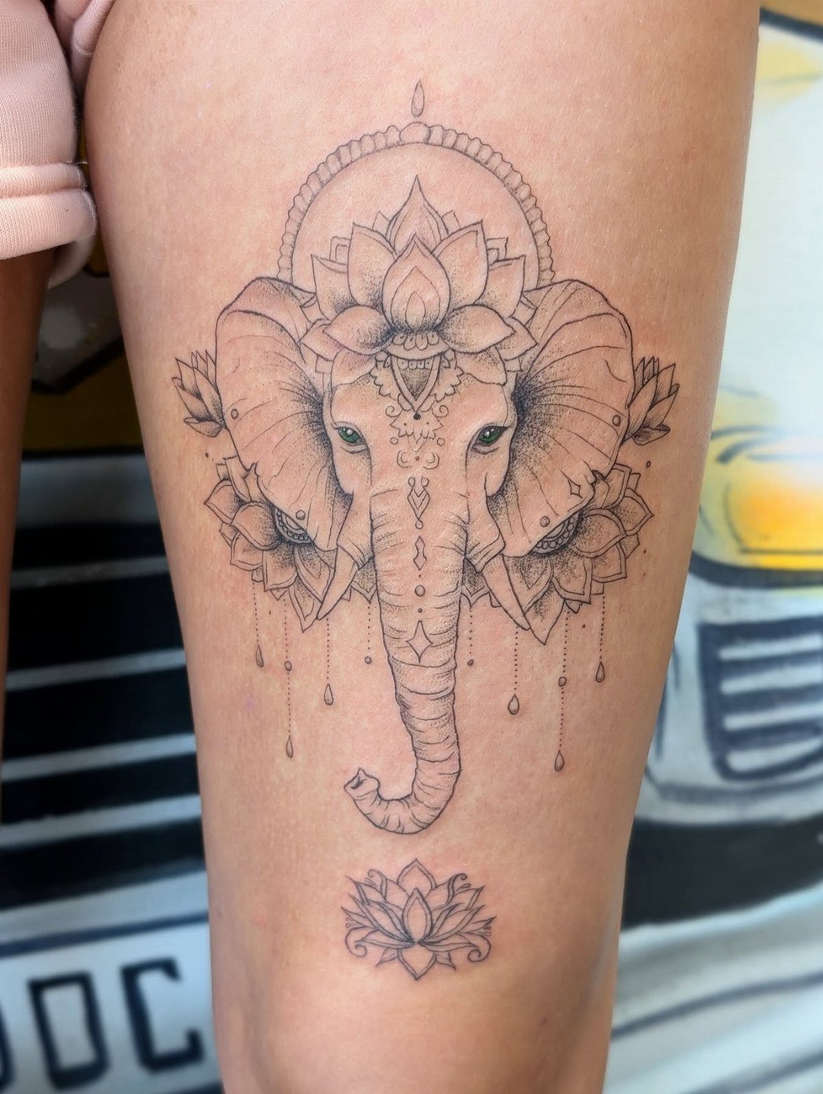 Fine Line Tattoo Aesthetic for Women: 9 Idea Boards 4 An elephant head tattoo with a lotus flower and fine line dotwork on a person's leg.