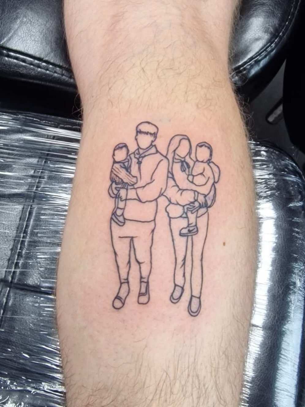 14 Tattoo Style Outline Ideas for Your Next Appointment 4 A minimalist fine-line tattoo of four family members on a person's leg.